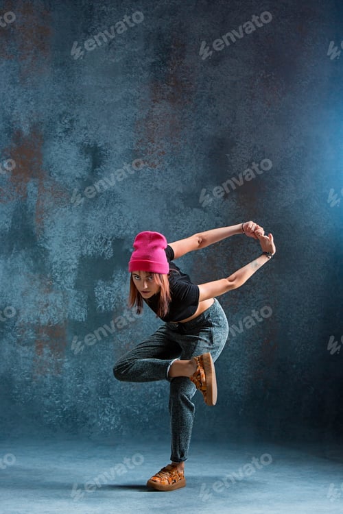 Preview: Young girl break dancing on wall background.