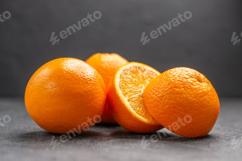 Preview: Horizontal view of whole and chopped fresh lemons on dark background stock image