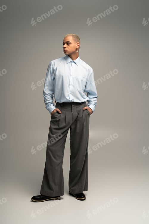Preview: Handsome stylish man poses confidently in elegant fashion statement against neutral backdrop