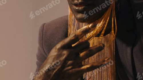 Preview: Close-up of black man with style. Creative. Beautiful stylish details of man with makeup and gold