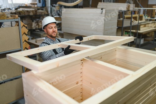 Preview: Carpenter placing wooden frame on furniture in workshop