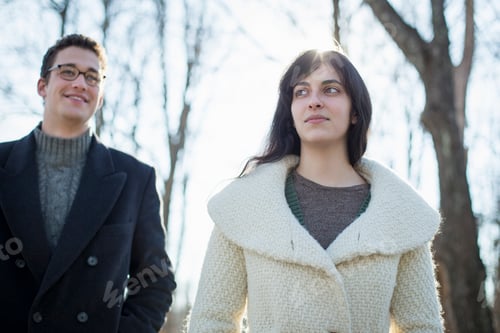 Preview: Two people, a couple, a man and woman in the woods on a winter day.