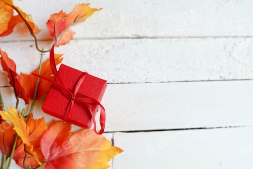 Preview: Bright Red Gift on White Wooden Planks