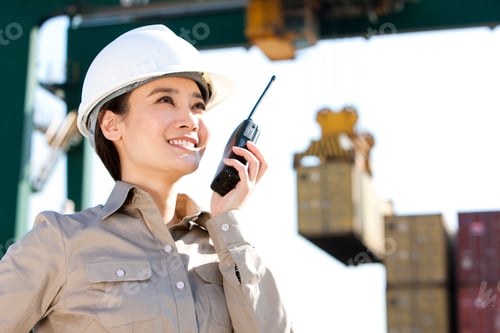Preview: Chinese shipping industry worker directing cranes with her walkie-talkie