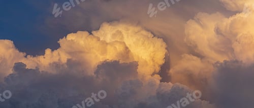 Preview: Beautiful banner shot of bright fluffy clouds in a sky at golden hour