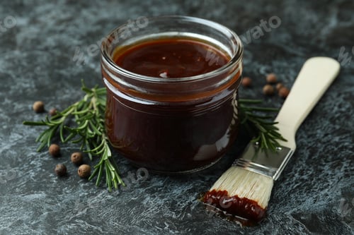 Preview: Barbecue sauce, spices and brush on black smoky background
