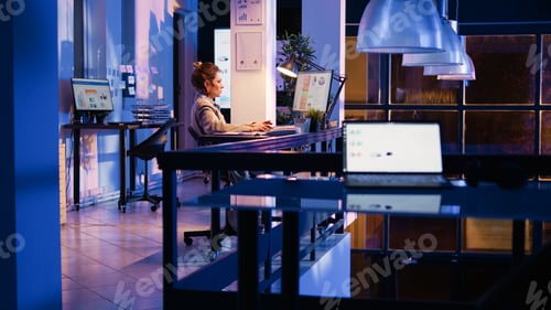 Preview: Happy entrepreneur analyzing online statistics late