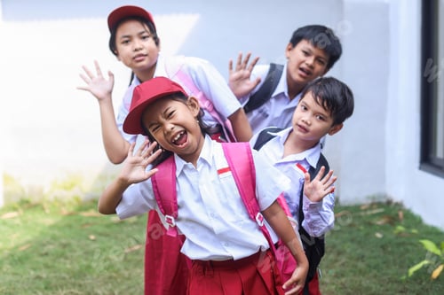 Preview: Happy Asian elementary school students standing in a row waving to camera cheerfully