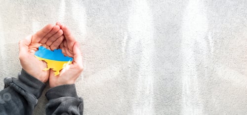 Preview: Hands holding national flag of Ukraine in the shape of the borders of Ukraine. Support for Ukraine