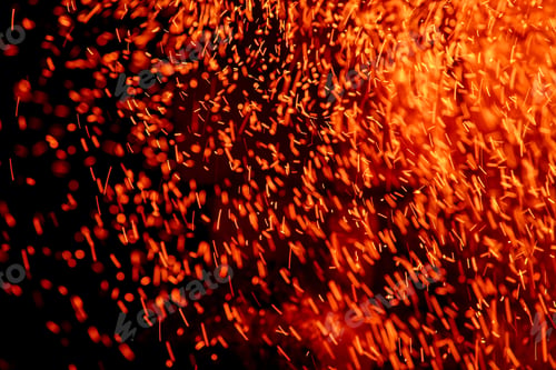 Preview: Flying sparks of flame on a dark background