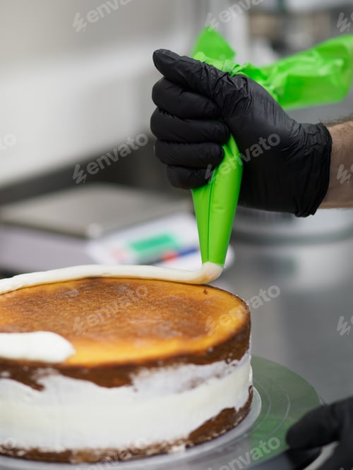 Preview: Pastry chef decorating a cake with blue icing