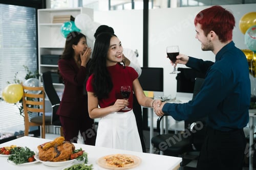 Preview: Four cheerful friends celebrate together in an office party, enjoying delicious food,fried chicken