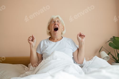 Preview: Portrait of beauty Caucasian 50s 60s woman awaking, wake up on the bed. Young beautiful female