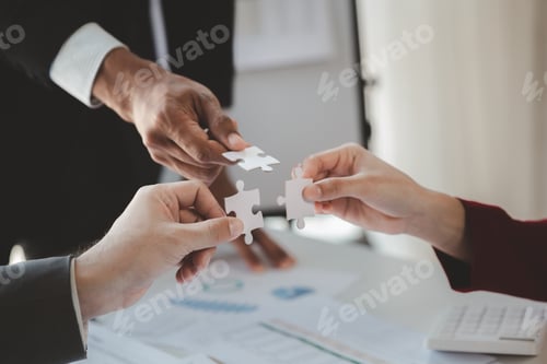 Preview: Group business people holding jigsaw puzzle together.