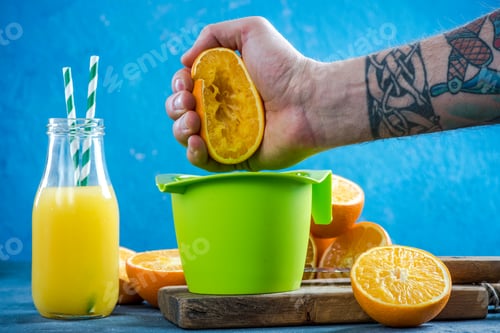 Preview: Hand squeezing orange halves for juice