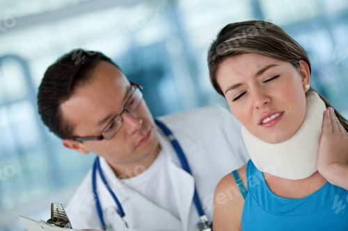 Preview: Injured Woman In Pain With A Physiotherapist Wearing A Surgical Collar