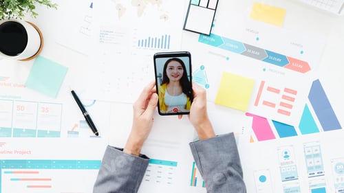 Preview: woman using phone talk to colleague about plan in video call meeting while work from home.