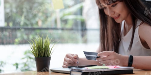 Preview: Smiling woman use mobile phone for shopping online with credit card