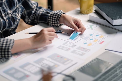 Preview: Close up App developer Ux Ui designing with paper model on mobile application prepare