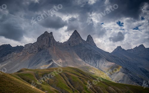 Preview: Landscape of rocky Aiguilles d'Arves under a cloudy sky