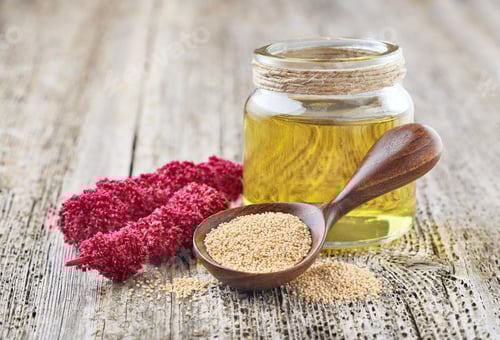 Preview: Amaranth oil with plant and seeds on wooden background