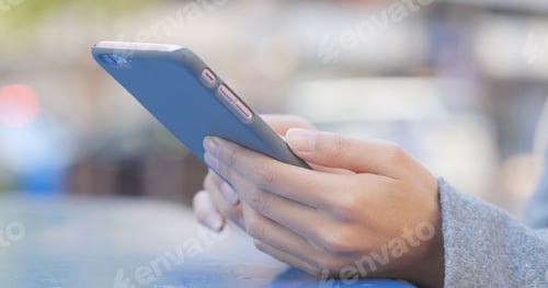 Preview: Woman Holding Cellphone in Blue Case
