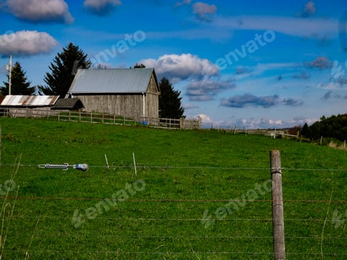 Preview: Scenic View of Barn in Rolling Green Pasture