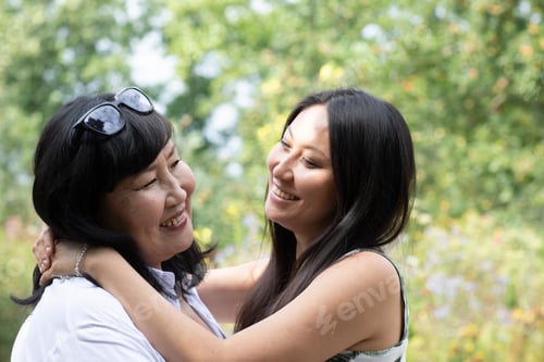 Preview: A heartwarming embrace between mother and daughter outdoors