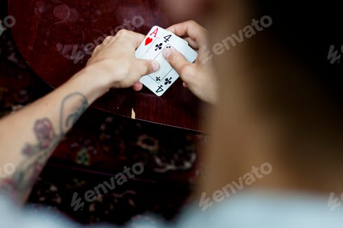 Preview: Cropped image of man playing cards at home