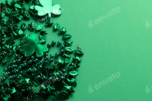 Preview: Image of green clover and jewellery and copy space on green background