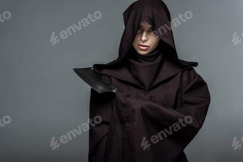Preview: woman in death costume holding cleaver isolated on grey