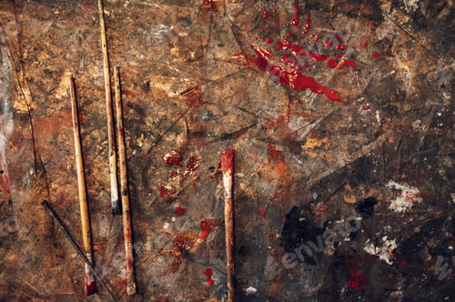 Preview: Dirty paintbrushes laying on the floor of an artist studio