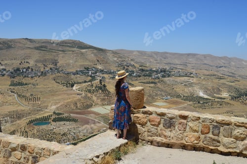 Preview: Young female tourist enjoying the beautiful view of ancient Kerak in Jordan
