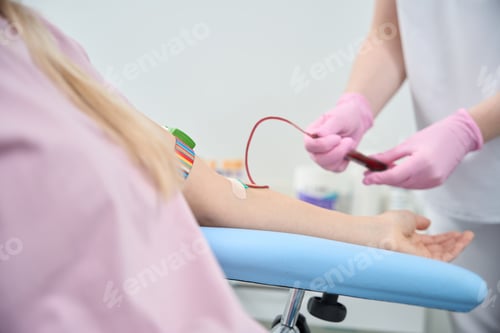 Preview: Qualified therapist connecting an IV, performing blood transfusion procedure