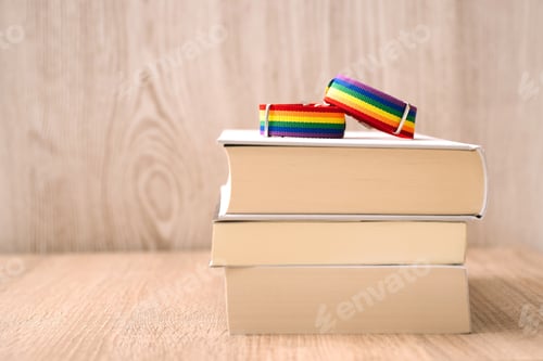 Preview: Lgtb collective bracelets on books and wooden background