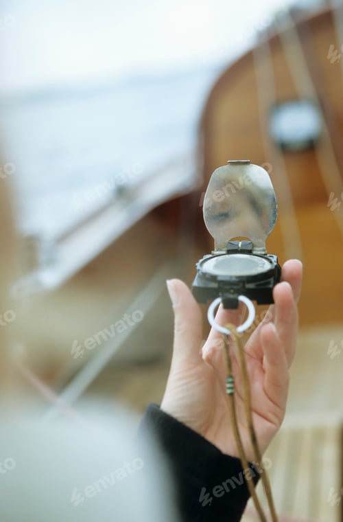 Preview: Close-up of person on boat holding compass