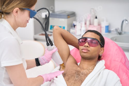 Preview: Experienced esthetician conducting underarm laser hair removal on client