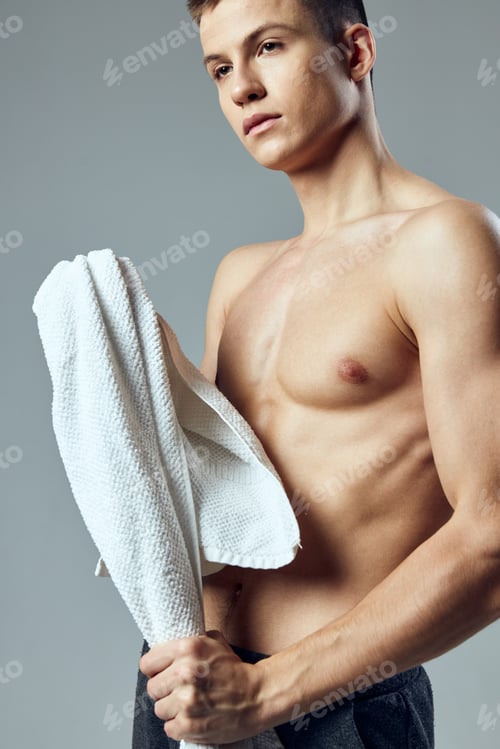 Preview: portrait of a sports guy naked torso towel in hand posing