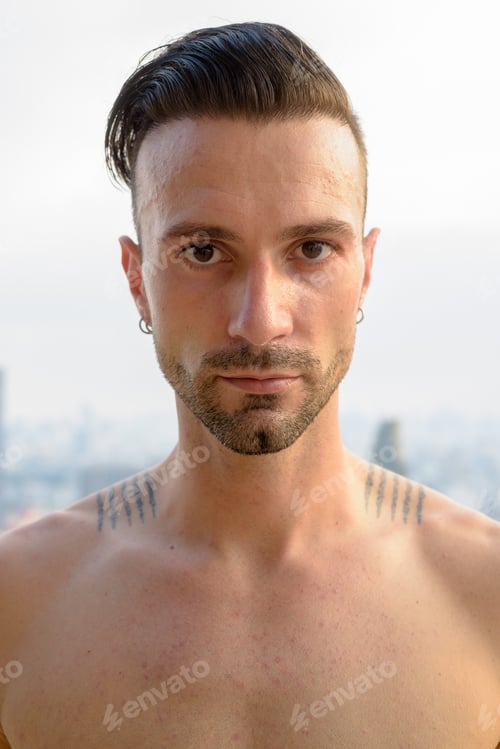 Preview: Portrait of handsome young man shirtless outdoors at rooftop in city