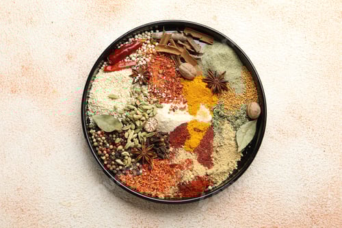 Preview: Different aromatic spices on beige textured table, top view