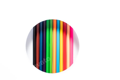 Preview: A set of colored pencils peek out of a circle on a white background. Sharpened pencils concept