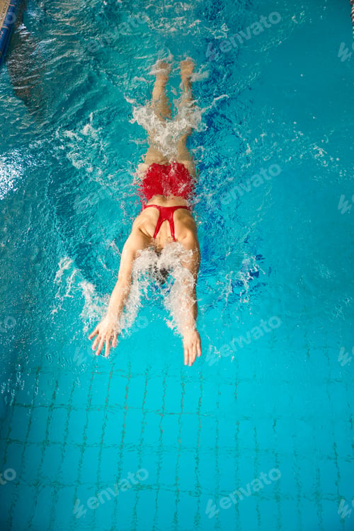 Preview: Caucasian female swimmer working out in water