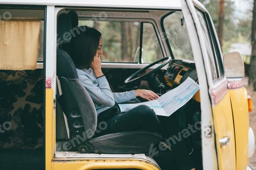 Preview: african american girl with map sitting in retro styled minivan