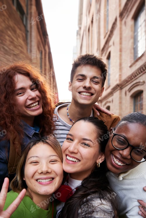 Preview: Cheerful group of multiethnic student friends taking a selfie together outdoors at university.