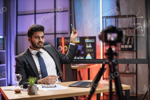 Preview: Attractive confident arab skilled bearded businessman explaining online economic charts