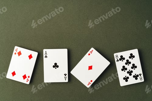 Preview: Playing cards on green background studio shot
