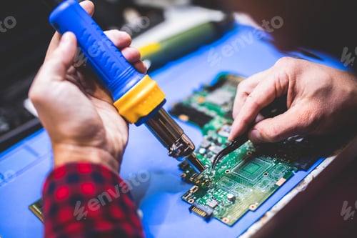 Preview: Man fixing main board of a computer.