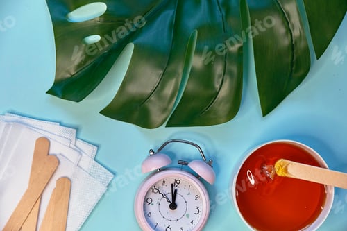 Preview: set of means of hair removal on a blue background. Wax strips. Minimalism, choice. top view