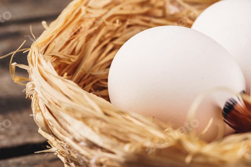 Preview: eggs in the hay nest on wooden table