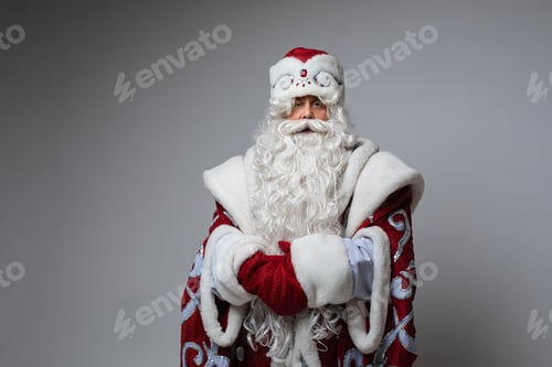 Preview: Calm Santa with hands together looking at camera.